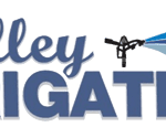 Logo for Valley Irrigation with the word "Valley" in blue script above "IRRIGATION" in bold letters, featuring an irrigation sprinkler spraying water in shades of blue above the text.